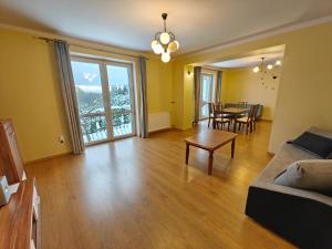 a living room with a couch and a table at Zacisze Grojeckie in Grojec
