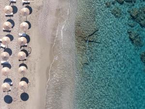 an overhead view of a beach with umbrellas and the ocean at Villa Theano in Triopetra