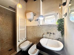 a bathroom with a sink and a toilet and a tub at LA COSTARELLA - Central with Cozy Terrace in Siena +49 photos