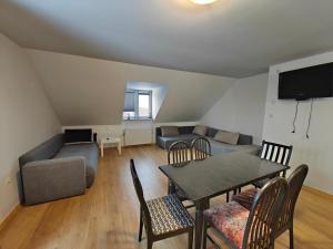 a living room with a table and a couch at Zacisze Grojeckie in Grojec