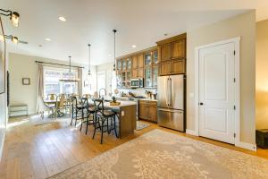 a kitchen with a table and chairs and a refrigerator at Hot Tub and Fire Pit Modern Flagstaff Home in Flagstaff