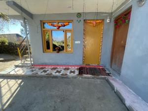 a front door of a house with a window at Munsiyari Eco homestay in Munsyari