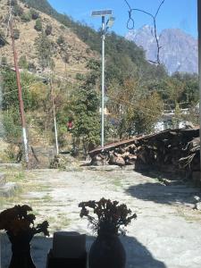 two vases sitting on a table near a bridge at Munsiyari Eco homestay in Munsyari