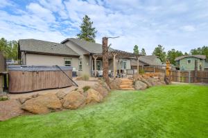 a house with a yard with rocks and a fence at Hot Tub and Fire Pit Modern Flagstaff Home in Flagstaff