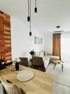 a living room with a table and a couch at Amber Central Residence in Baia Mare +14 photos