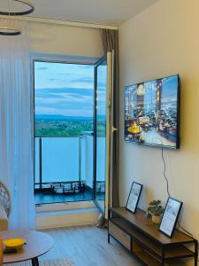 a living room with a large window with a view at Amber Central Residence in Baia Mare