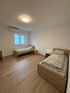 a bedroom with two beds and a window at VP sobe in Ilirska Bistrica