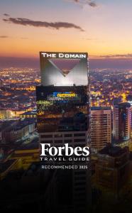 a sign on top of a building in a city at The Domain Bahrain Hotel and Spa - Adults Friendly 16 Years Plus in Manama