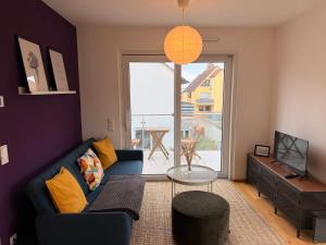 a living room with a blue couch and a tv at Gemütliches Wohnen in Worms