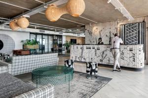 a man standing at a counter in a lobby at Apartment with Mountain views Wex1 in Cape Town