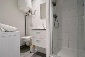 ein weißes Badezimmer mit Dusche und Toilette in der Unterkunft Le Duo - Les Demeures d'Adrien in Carvin + 13 Fotos