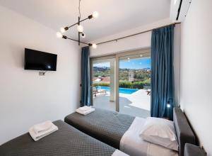 a bedroom with a bed and a view of a pool at Tina by Vintage Travel in Spartokhórion +40 photos