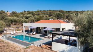 a villa with a swimming pool and a house at Tina by Vintage Travel in Spartokhórion