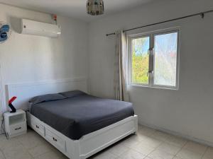 Ένα ή περισσότερα κρεβάτια σε δωμάτιο στο Azur Beach Complex - 1 min from Pereybere beach