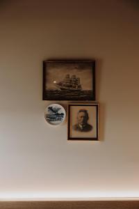 two pictures of a man on a wall at Bryggjan Boutique Hotel in Akureyri +43 photos