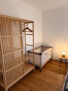 a room with a bunk bed and a wooden floor at Romantisches wohnen in Worms