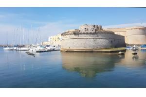 un grande edificio in riva al mare, accanto alle barche di Dimore di Matilde - Mare Fuori a Gallipoli
