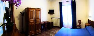 a living room with a cabinet and a blue couch at Albergo Delle Alpi in Miroglio