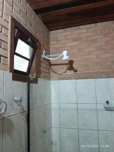a bathroom with a shower and a window at Pousada Mar Azul in Trindade +83 photos