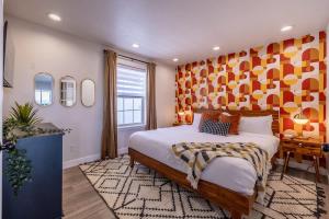 una camera con un grande letto con una parete arancione di Hot Tub w Mountain View a Westminster