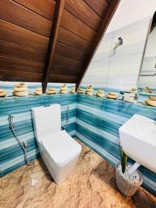 a bathroom with a toilet and a sink at Soluna Cove luxury Cabanas Hikkaduwa in Hikkaduwa +45 photos