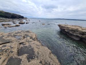 a large body of water with rocks in it at Clochan na Mara - Liscannor, County Clare & Wild Atlantic Way in Liscannor