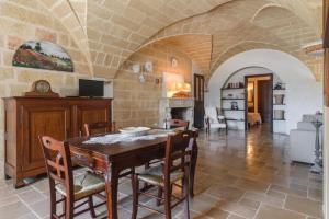 Una cocina y un comedor con mesa y sillas. en Le Lantane - Luxury Rooms, en Alessano