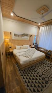 una camera con un grande letto con un tappeto di Oakridge By The Aravali Story a Dhanaulti