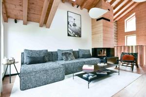 a living room with a couch and a fireplace at Chalet Mademoiselle in Les Allues +16 photos