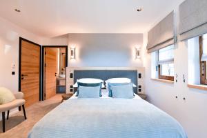 a bedroom with a large bed with blue pillows at Chalet Mademoiselle in Les Allues