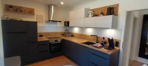 a kitchen with white and blue cabinets and a sink at renovierte Altbauwohnung im Oberallgäu in Immenstadt im Allgäu +19 photos