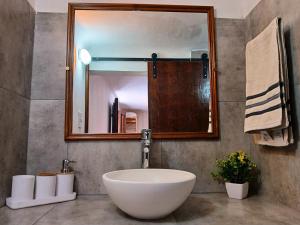 a bathroom with a large white sink and a mirror at Depto 1615 in Villa Mercedes +17 photos