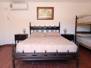 a bed in a room with two nightstands and a bed sidx sidx sidx at Depto 1615 in Villa Mercedes