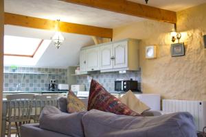 a living room with a couch and a kitchen at Atlantic View Cottages in Doolin