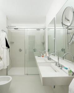 a bathroom with three sinks and a shower at Hotel Posa Posa in Positano +151 photos