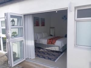 a bedroom with a bed and a window at M Group B&B in King Williamʼs Town +37 photos