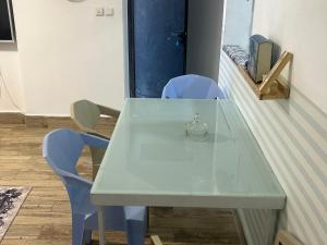 a table with two blue chairs and a green table at Lady of the DeadSea Crown Group Collection in Neve Zohar