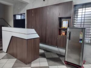 a kitchen with a counter and a refrigerator at Mount Bliss Stay in Tiruvannāmalai