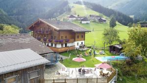 a large house with a playground and a swimming pool at Unterdacheben in Dienten am Hochkönig
