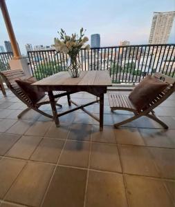 una mesa y sillas en un balcón con un jarrón de flores en Baan Tanwa - MRT Ratchadapisek Exit 1 or 2, en Bangkok 114 fotos más