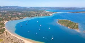 an aerial view of a beach with boats in the water at Residence with swimming pool in Costa Serena just 700 mt from the sea in Porto Rafael +30 photos
