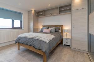 a bedroom with a large bed and a window at Ty-Mari in Harlech