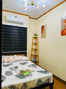a bedroom with a bed and a window with a fan at H&K Guest House in Urdaneta +34 photos