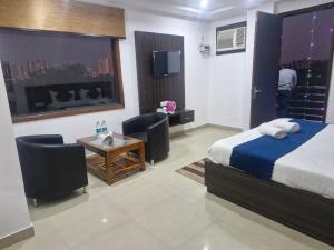 Voodi või voodid majutusasutuse Yashobhoomi Grand toas