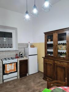 a kitchen with a white refrigerator and a stove at Casa Vacanze da Nonna Chiarina in Anagni