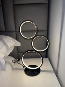 two mirrors on a table next to a bed at Fonte Retreat Premium Suite in Sandim