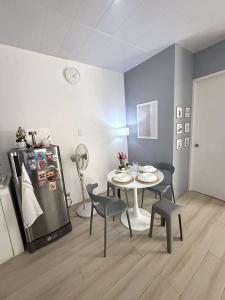 a dining room with a table and a refrigerator at H&K Partner Guest House 