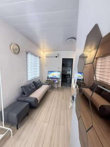 a living room with a couch and a tv at H&K Partner Guest House  +21 photos