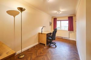 an office with a desk and a chair and a lamp at Host & Stay - Riders Rest in Wootton +21 photos