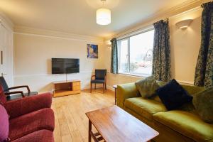 a living room with a couch and a tv at Host & Stay - Riders Rest in Wootton +22 photos